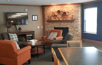 A living room with a fireplace and a flat screen TV.